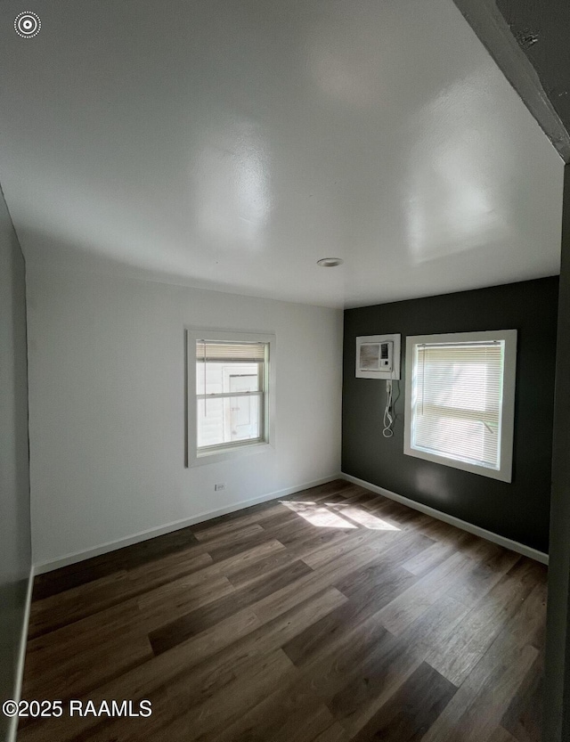 1136 Tupelo St, New Iberia, LA 70560 - empty room with plenty of natural light, dark wood-style flooring, and a wall mounted AC