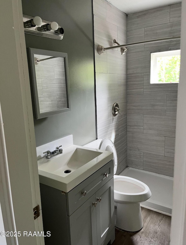 1136 Tupelo St, New Iberia, LA 70560 - full bathroom featuring vanity, tiled shower, and wood finished floors