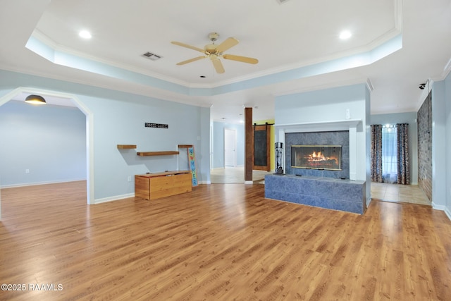 1034 Hollow Oaks Rd, Breaux Bridge, LA 70517 - unfurnished living room featuring a tray ceiling, ornamental molding, ceiling fan, light wood-style floors, and recessed lighting