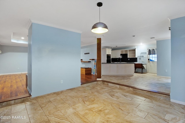 1034 Hollow Oaks Rd, Breaux Bridge, LA 70517 - kitchen featuring ornamental molding, dark countertops, white cabinetry, open floor plan, and pendant lighting