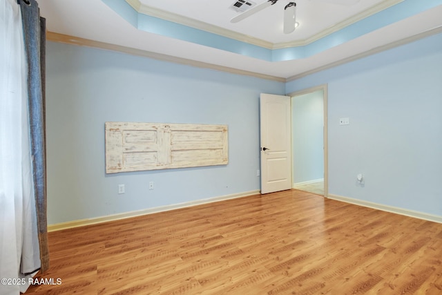 1034 Hollow Oaks Rd, Breaux Bridge, LA 70517 - spare room featuring ornamental molding, light wood finished floors, a raised ceiling, and a ceiling fan