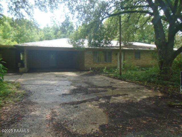 1248 N Portage Rd, Arnaudville, LA 70512 - ranch-style home with driveway and a carport