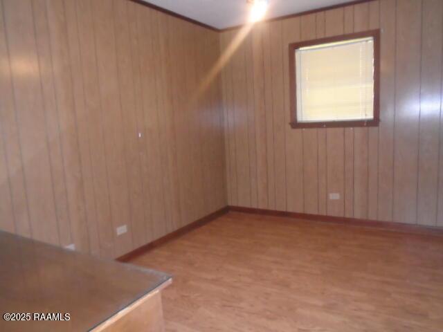 1248 N Portage Rd, Arnaudville, LA 70512 - spare room featuring light wood-style flooring and wood walls