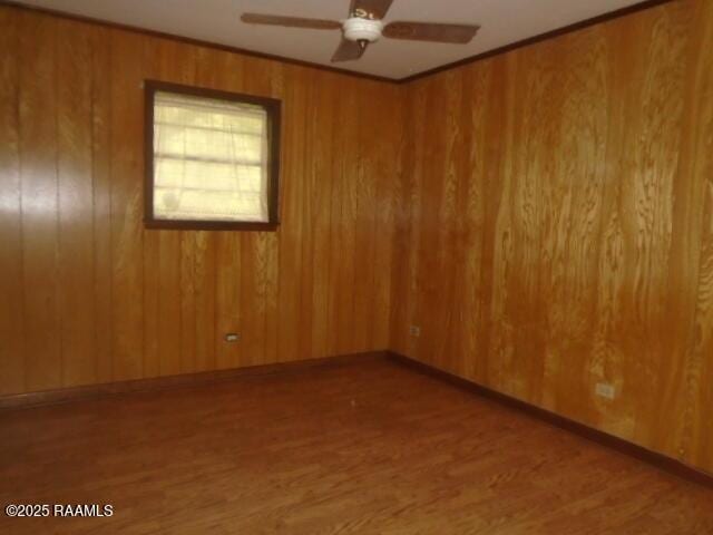 1248 N Portage Rd, Arnaudville, LA 70512 - spare room with wood finished floors, ceiling fan, and wooden walls