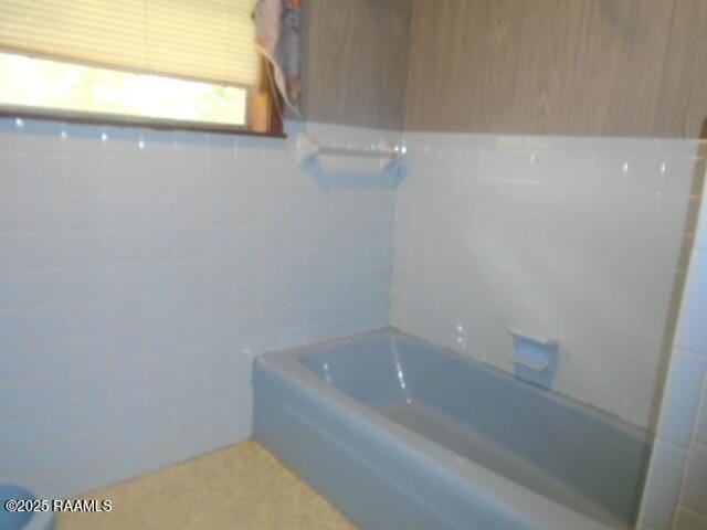 1248 N Portage Rd, Arnaudville, LA 70512 - full bath featuring tile walls and shower / tub combination