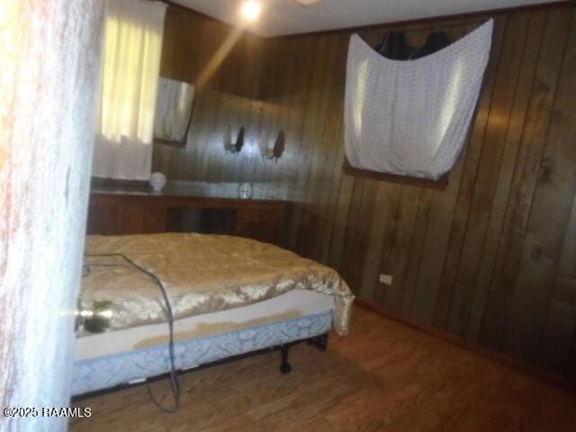 1248 N Portage Rd, Arnaudville, LA 70512 - bedroom featuring wooden walls and wood finished floors