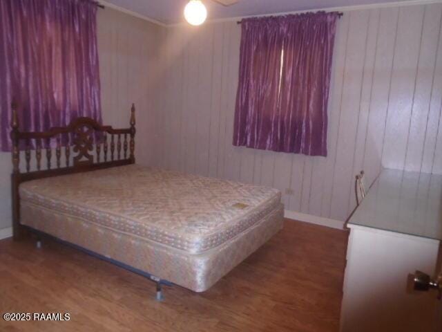 1248 N Portage Rd, Arnaudville, LA 70512 - bedroom with wood finished floors and wooden walls