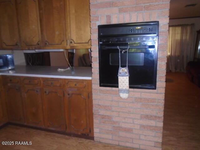 1248 N Portage Rd, Arnaudville, LA 70512 - kitchen featuring oven, light countertops, and brown cabinets