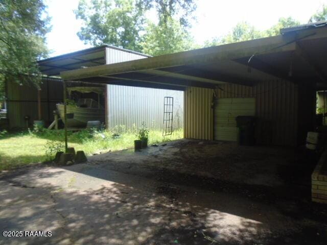 1248 N Portage Rd, Arnaudville, LA 70512 - view of car parking featuring driveway and an attached carport