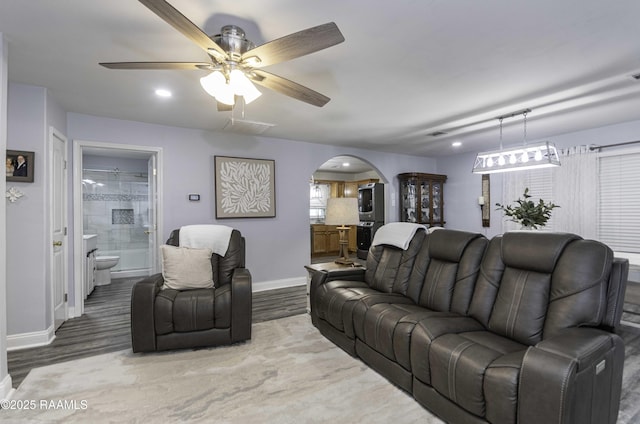 411 Donald St, New Iberia, LA 70563 - living room with arched walkways, wood finished floors, and ceiling fan