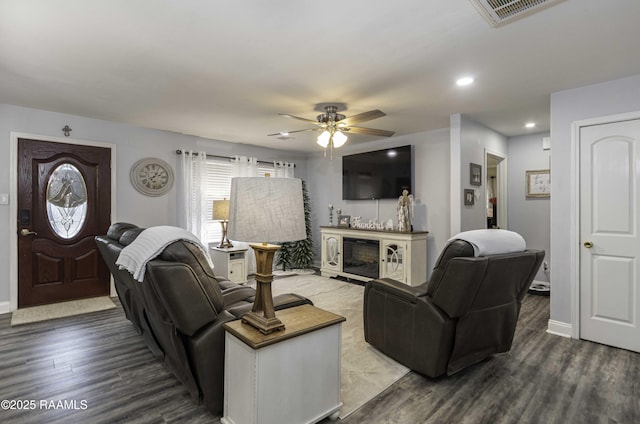 411 Donald St, New Iberia, LA 70563 - living area featuring a ceiling fan, wood finished floors, a glass covered fireplace, and recessed lighting