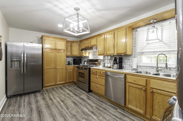 411 Donald St, New Iberia, LA 70563 - kitchen featuring stainless steel appliances, under cabinet range hood, decorative backsplash, dark wood-style floors, and light countertops