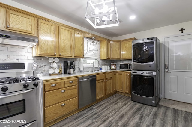 411 Donald St, New Iberia, LA 70563 - kitchen featuring appliances with stainless steel finishes, stacked washer and clothes dryer, under cabinet range hood, tasteful backsplash, and light countertops