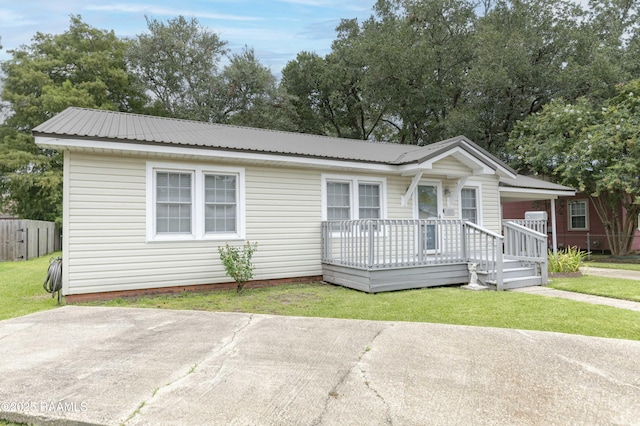 411 Donald St, New Iberia, LA 70563 - view of front of property with a metal roof and a front lawn