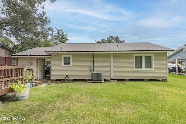 411 Donald St, New Iberia, LA 70563 - rear view of house featuring a lawn and a metal roof