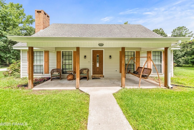 3317 Walnut Dr, Opelousas, LA 70570 - bungalow featuring a front yard, a shingled roof, a chimney, and a porch