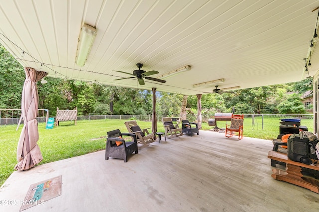 3317 Walnut Dr, Opelousas, LA 70570 - fenced backyard featuring ceiling fan, a patio area, and view of wooded area
