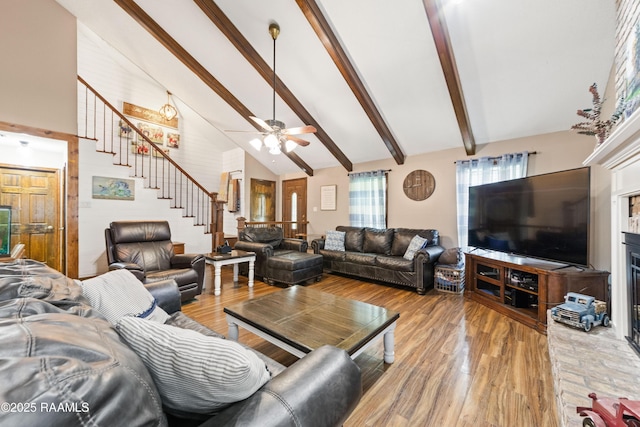 3317 Walnut Dr, Opelousas, LA 70570 - living room featuring stairway, high vaulted ceiling, beam ceiling, light wood finished floors, and a ceiling fan