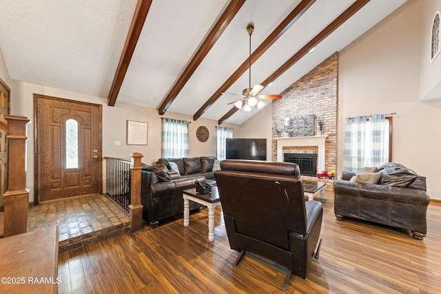 3317 Walnut Dr, Opelousas, LA 70570 - living area with wood finished floors, ceiling fan, a brick fireplace, beamed ceiling, and high vaulted ceiling