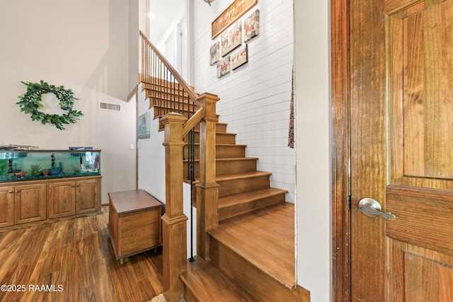3317 Walnut Dr, Opelousas, LA 70570 - stairway featuring wood finished floors and a towering ceiling