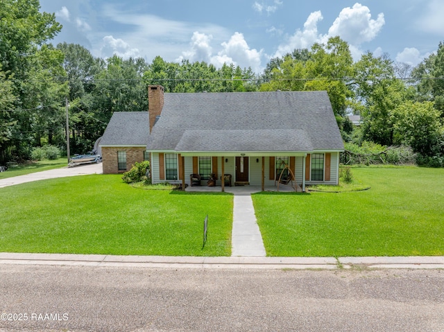 3317 Walnut Dr, Opelousas, LA 70570 - view of front of property with a porch, a front lawn, a chimney, and driveway