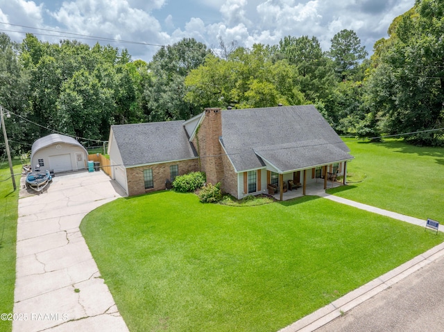 3317 Walnut Dr, Opelousas, LA 70570 - view of front facade with covered porch, a detached garage, a chimney, an outbuilding, and a shingled roof