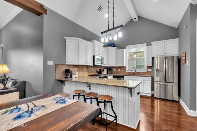 103 Cane Creek Dr, Broussard, LA 70518 - kitchen with stainless steel appliances, beam ceiling, white cabinets, light stone counters, and backsplash