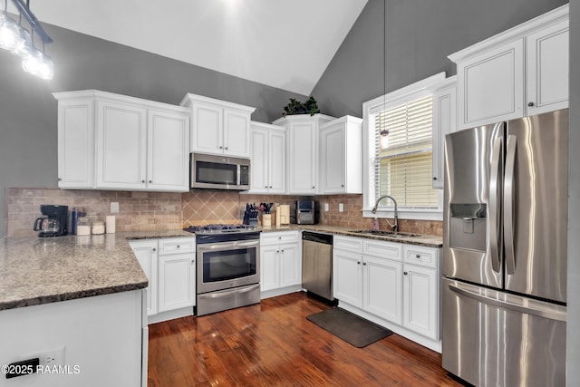103 Cane Creek Dr, Broussard, LA 70518 - kitchen featuring stainless steel appliances, lofted ceiling, white cabinets, backsplash, and light stone countertops