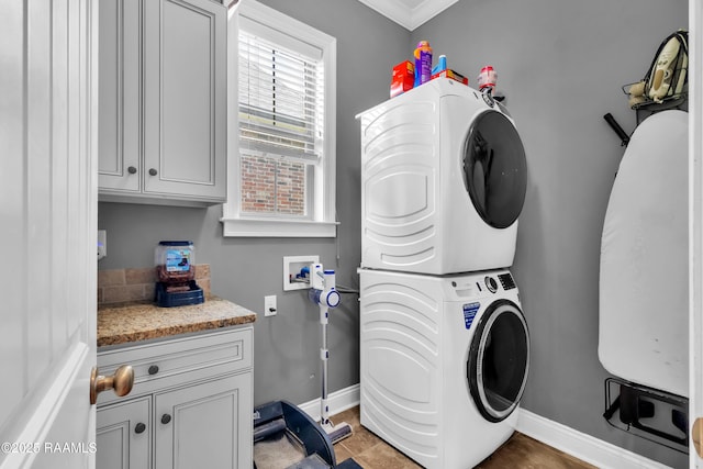 103 Cane Creek Dr, Broussard, LA 70518 - washroom featuring stacked washer and clothes dryer, cabinet space, and ornamental molding