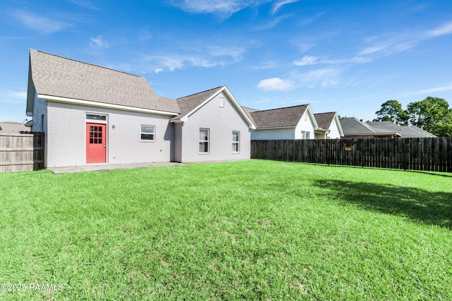 202 Saint Matthias Dr, Carencro, LA 70520 - back of property with a fenced backyard, brick siding, and a shingled roof