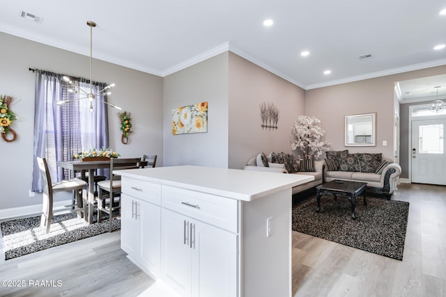 202 Saint Matthias Dr, Carencro, LA 70520 - kitchen with light wood-style flooring, a chandelier, a center island, crown molding, and recessed lighting