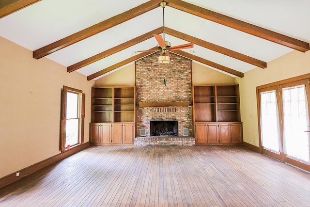 1867 N Old 179, Whigham, GA 39897 - unfurnished living room featuring hardwood / wood-style floors, beam ceiling, ceiling fan, a brick fireplace, and high vaulted ceiling