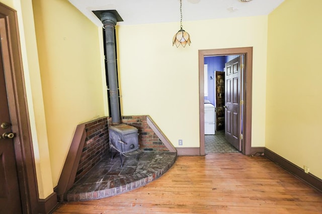 1867 N Old 179, Whigham, GA 39897 - unfurnished living room featuring a wood stove and wood finished floors