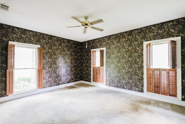 1867 N Old 179, Whigham, GA 39897 - spare room with carpet floors, ceiling fan, and wallpapered walls