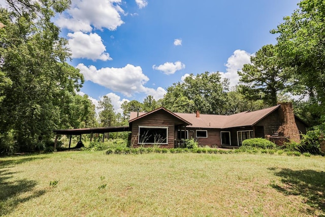 1867 N Old 179, Whigham, GA 39897 - rear view of property featuring a chimney and a lawn