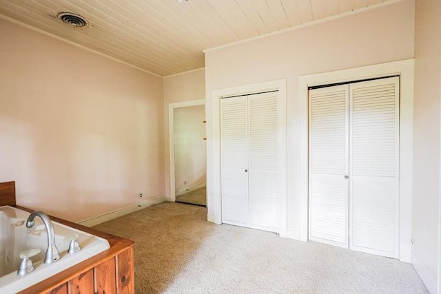 1867 N Old 179, Whigham, GA 39897 - unfurnished bedroom with carpet floors, two closets, ornamental molding, and wooden ceiling