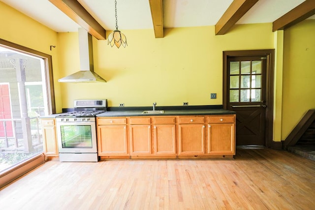 1867 N Old 179, Whigham, GA 39897 - kitchen with stainless steel range with gas cooktop, wall chimney range hood, beamed ceiling, light wood finished floors, and dark countertops