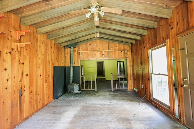 1867 N Old 179, Whigham, GA 39897 - unfurnished room with a wood stove, wooden walls, wood-type flooring, and ceiling fan