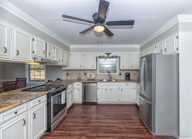 kitchen with sink, dark stone countertops, white cabinetry, and stainless steel appliances