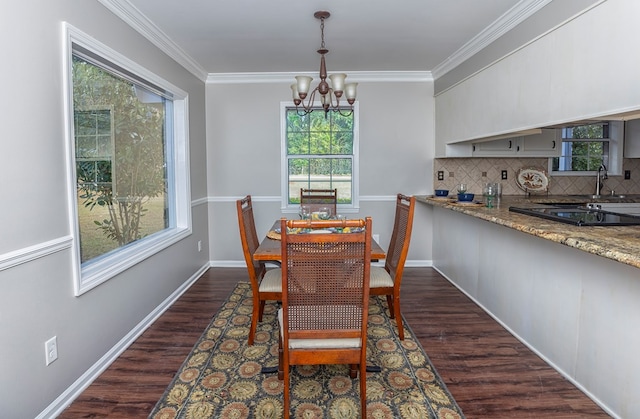 dining room featuring ornamental molding, dark wood-type flooring, and a notable chandelier