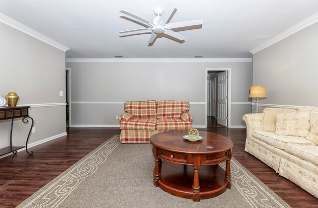 living room with dark hardwood / wood-style floors, ceiling fan, and crown molding