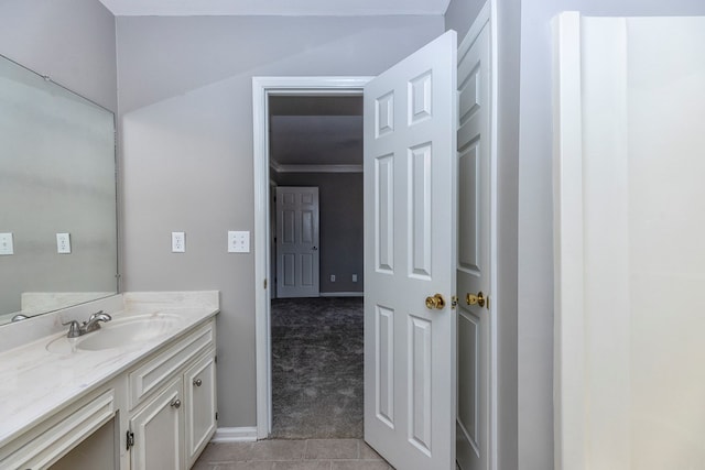 bathroom featuring tile patterned floors, crown molding, and vanity