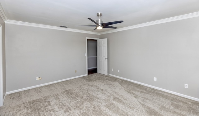 unfurnished room with light colored carpet, ceiling fan, and ornamental molding