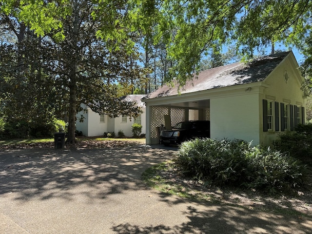 1420 Parallel Dr NW, Cairo, GA 39828 - view of side of home featuring an outdoor structure, brick siding, aphalt driveway, and an attached carport