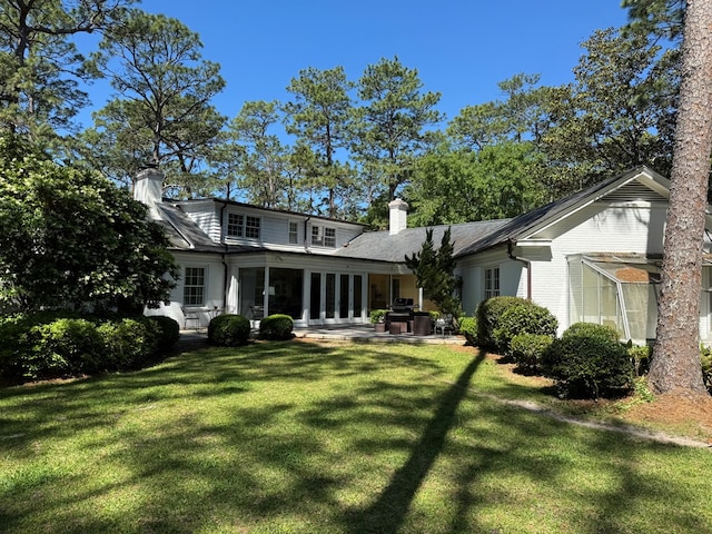 1420 Parallel Dr NW, Cairo, GA 39828 - back of house featuring a chimney, a yard, and a patio