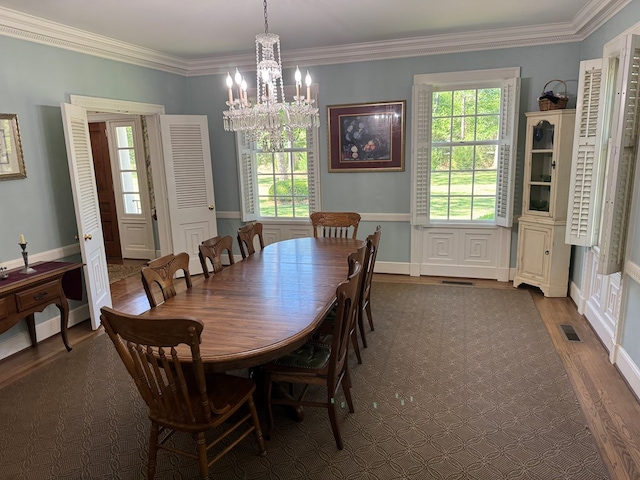 1420 Parallel Dr NW, Cairo, GA 39828 - dining area with a chandelier, dark wood finished floors, visible vents, and ornamental molding
