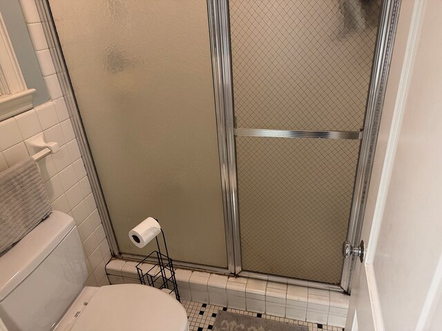 1420 Parallel Dr NW, Cairo, GA 39828 - full bathroom with a shower stall, toilet, tile walls, and tile patterned floors