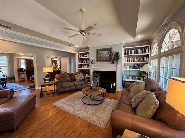 2451 Lake Douglas Rd, Bainbridge, GA 39819 - living room featuring crown molding, built in features, wood finished floors, and visible vents