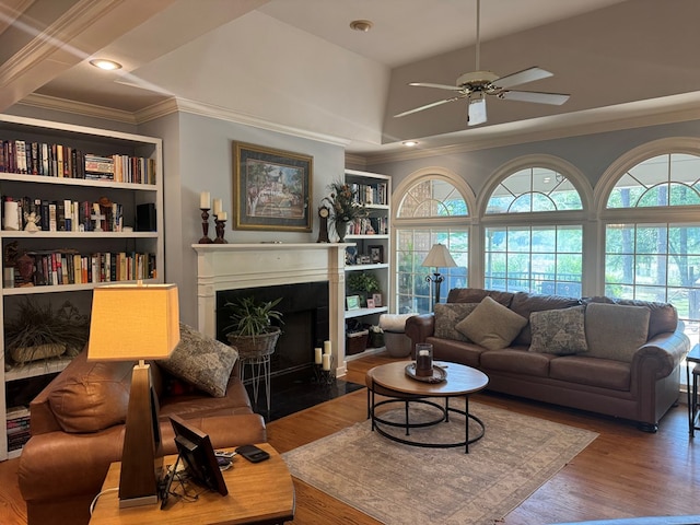 2451 Lake Douglas Rd, Bainbridge, GA 39819 - living area featuring a fireplace with flush hearth, wood finished floors, ceiling fan, and crown molding