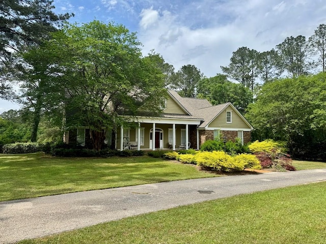 2451 Lake Douglas Rd, Bainbridge, GA 39819 - greek revival inspired property with brick siding, a porch, and a front yard